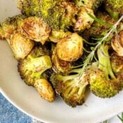 roasted Brussels sprouts and broccoli in a light grey bowl.