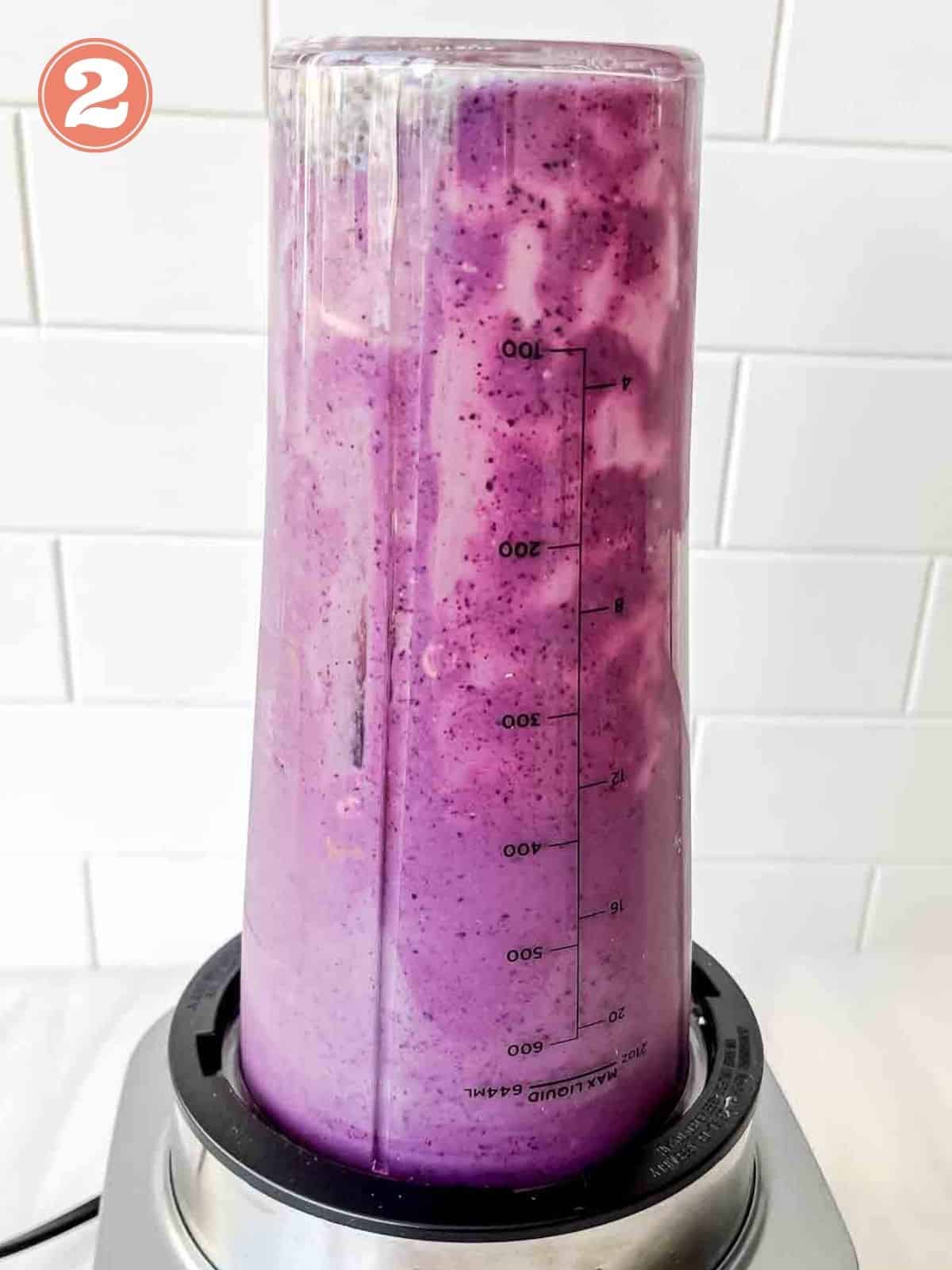 blueberry smoothie in a high speed blender labelled number two.