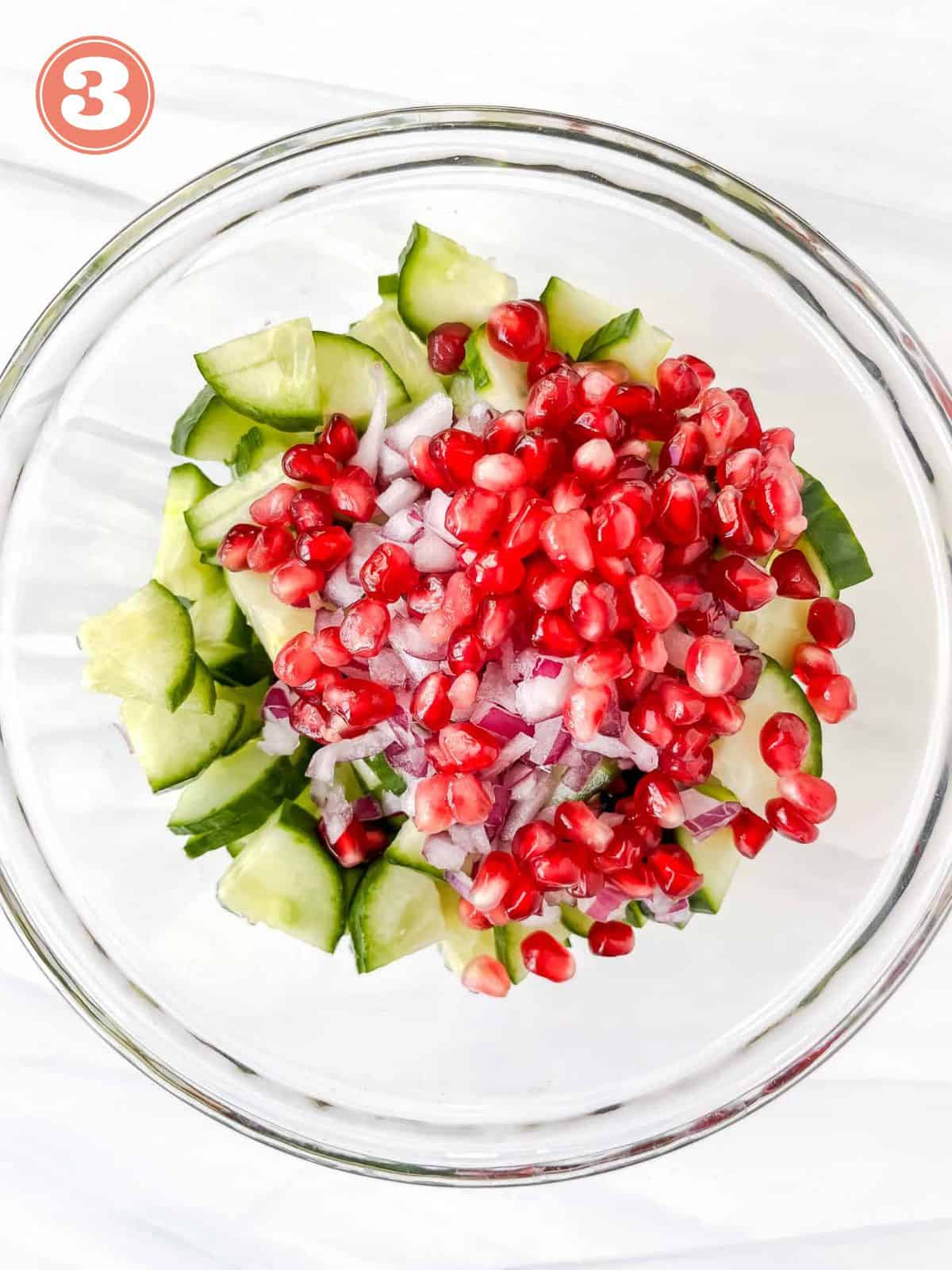 English cucumber and pomegranate seeds in a glass bowl labelled number three.