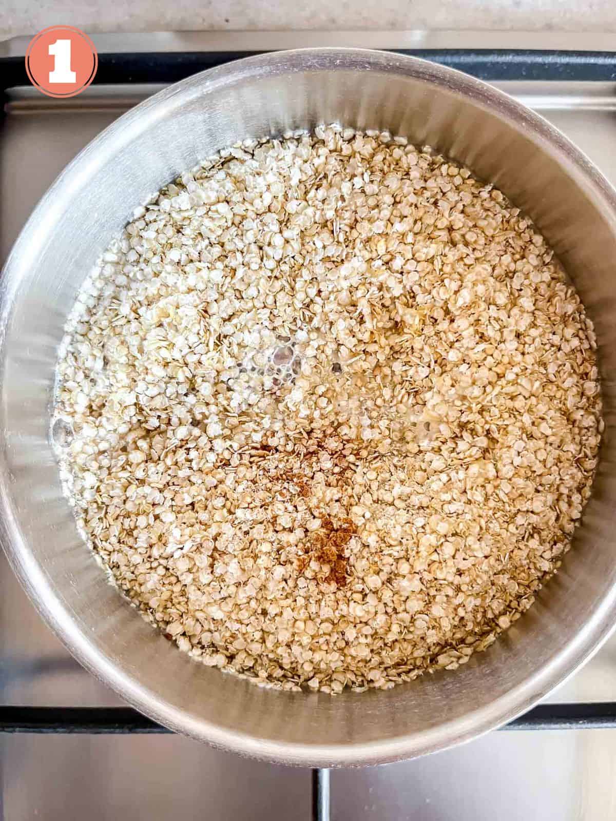 quinoa flakes, milk and cinnamon in a pot on a stovetop labelled number one.