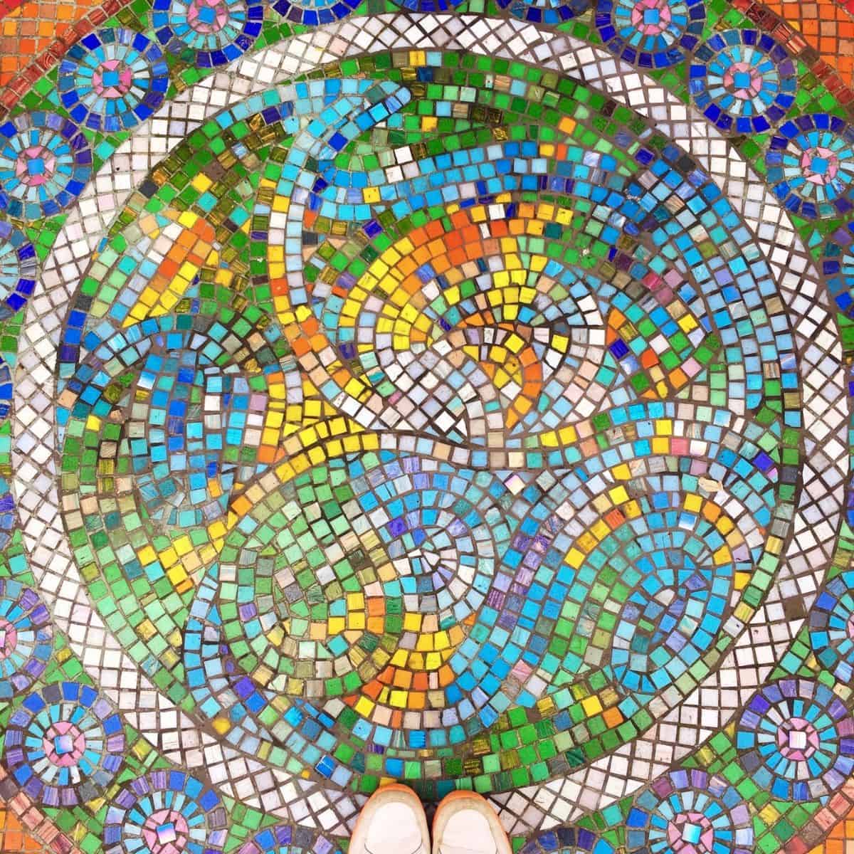 circle mosaic with feet on it.