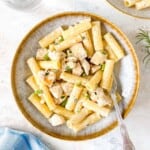 chicken mascarpone pasta in a light grey bowl with a fork in it.