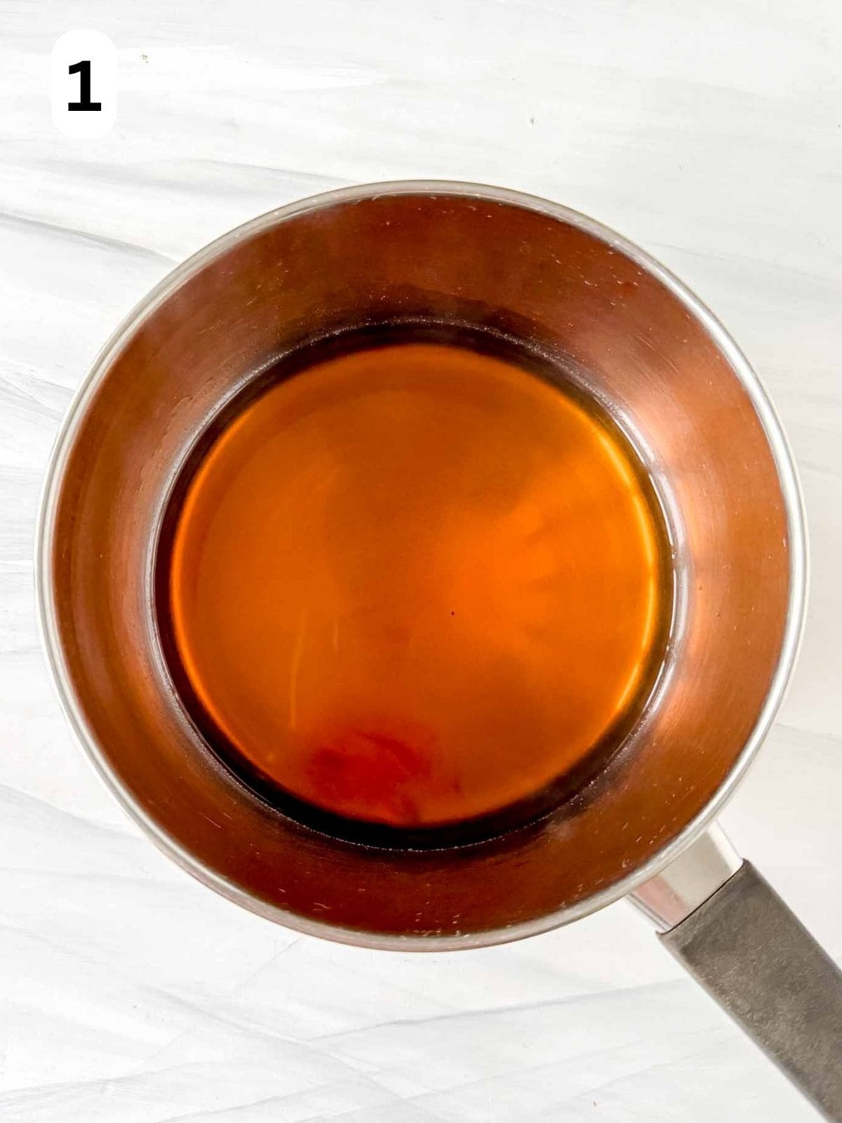 brown sugar dissolved in apple juice in a pot labelled number one.