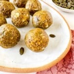 nut free energy balls on a white plate.