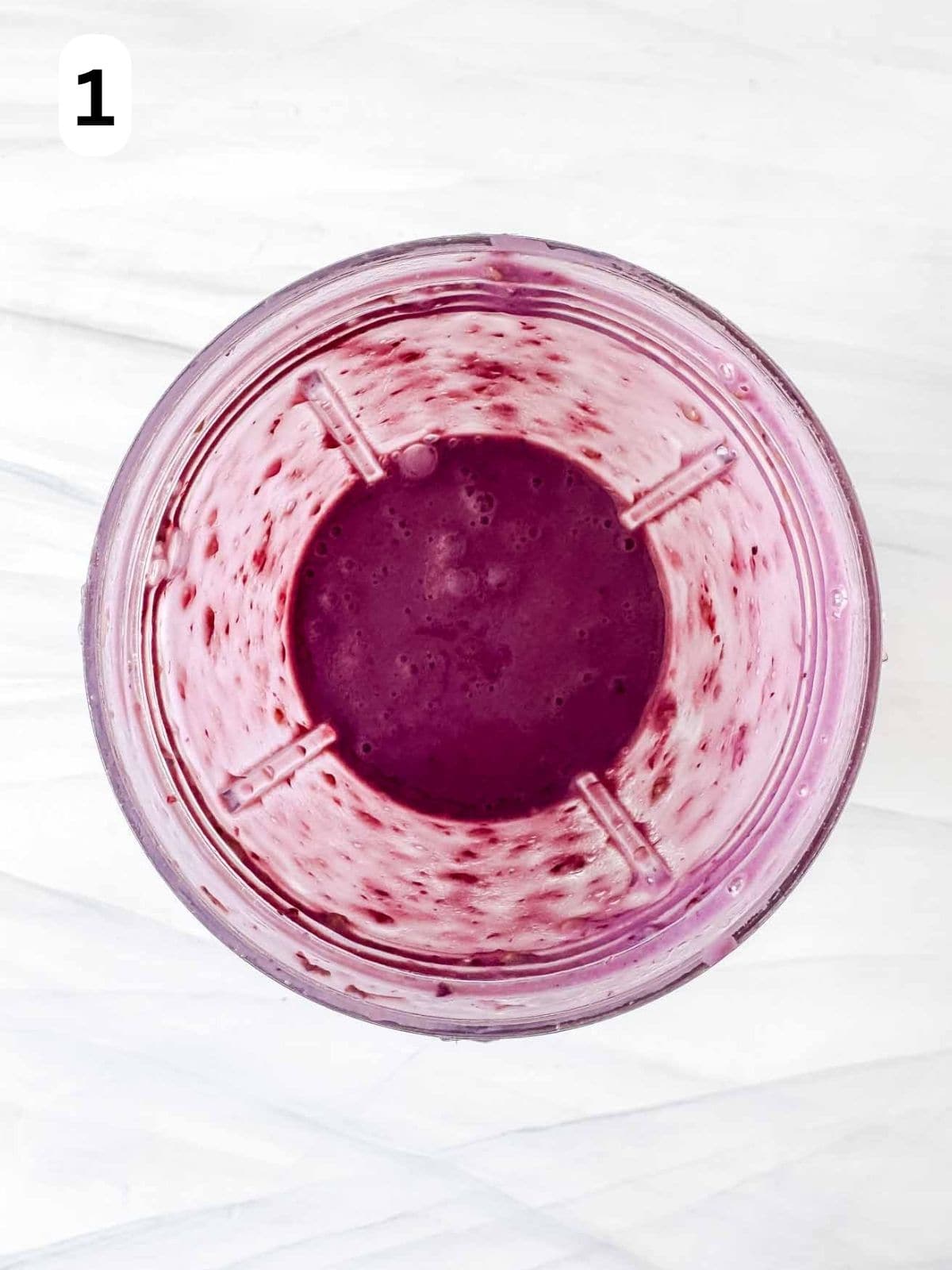 blended blackberries and plant milk in a blender cup labelled number one.