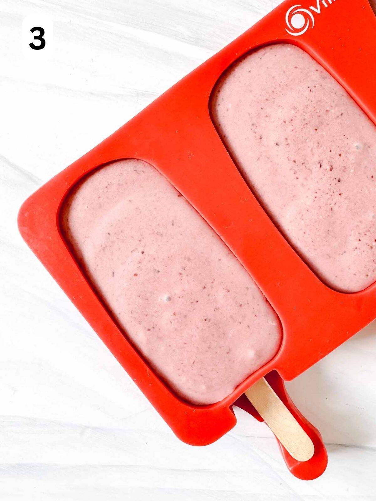 cherry popsicles in a red popsicle mold labelled number three.