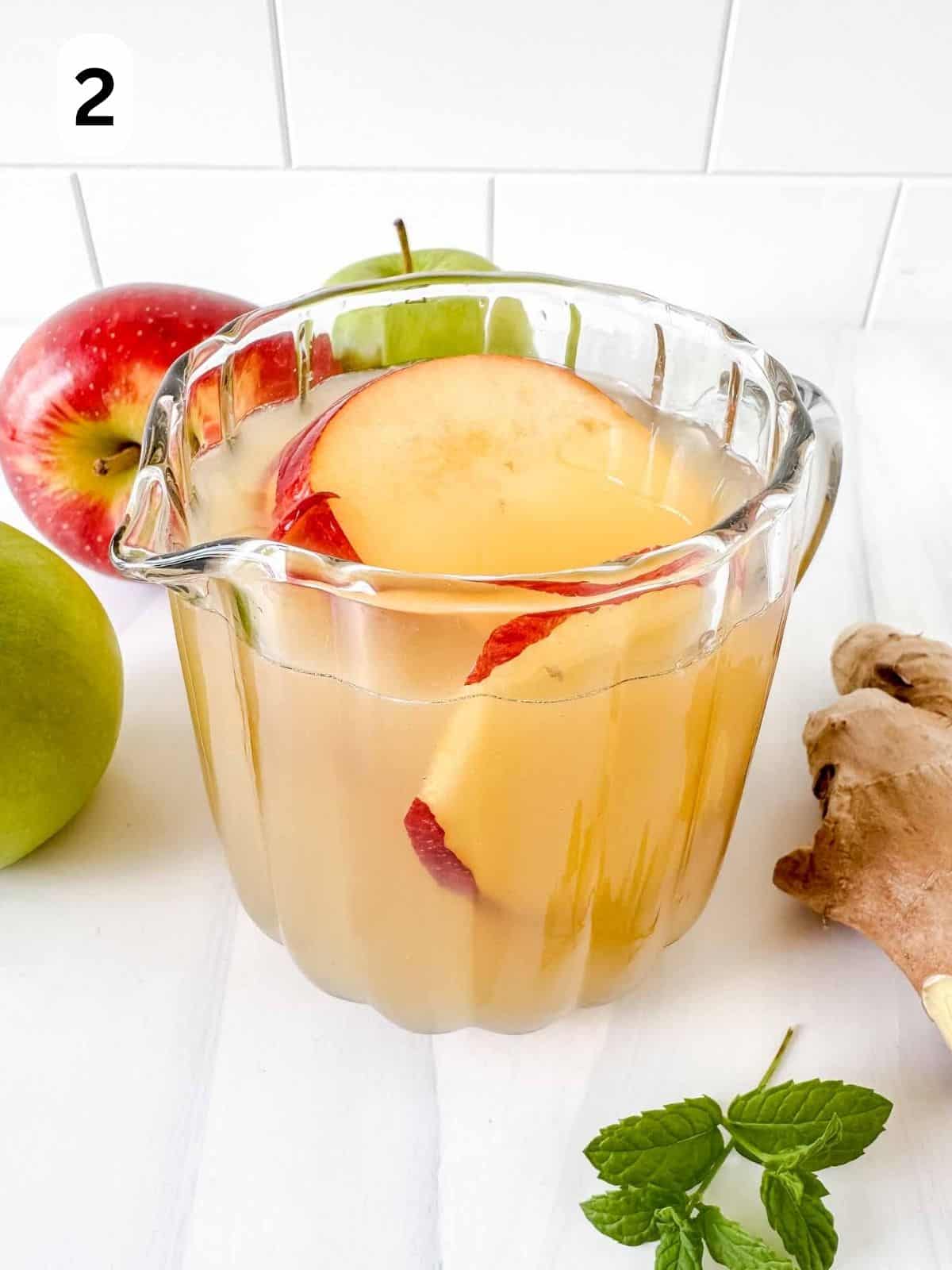 apple juice in a jug with apple slices labelled number two.