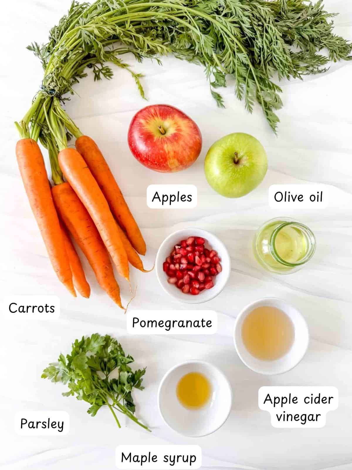 individually labelled carrots, apples, pomegranate, parsley, olive oil, apple cider vinegar and maple syrup.