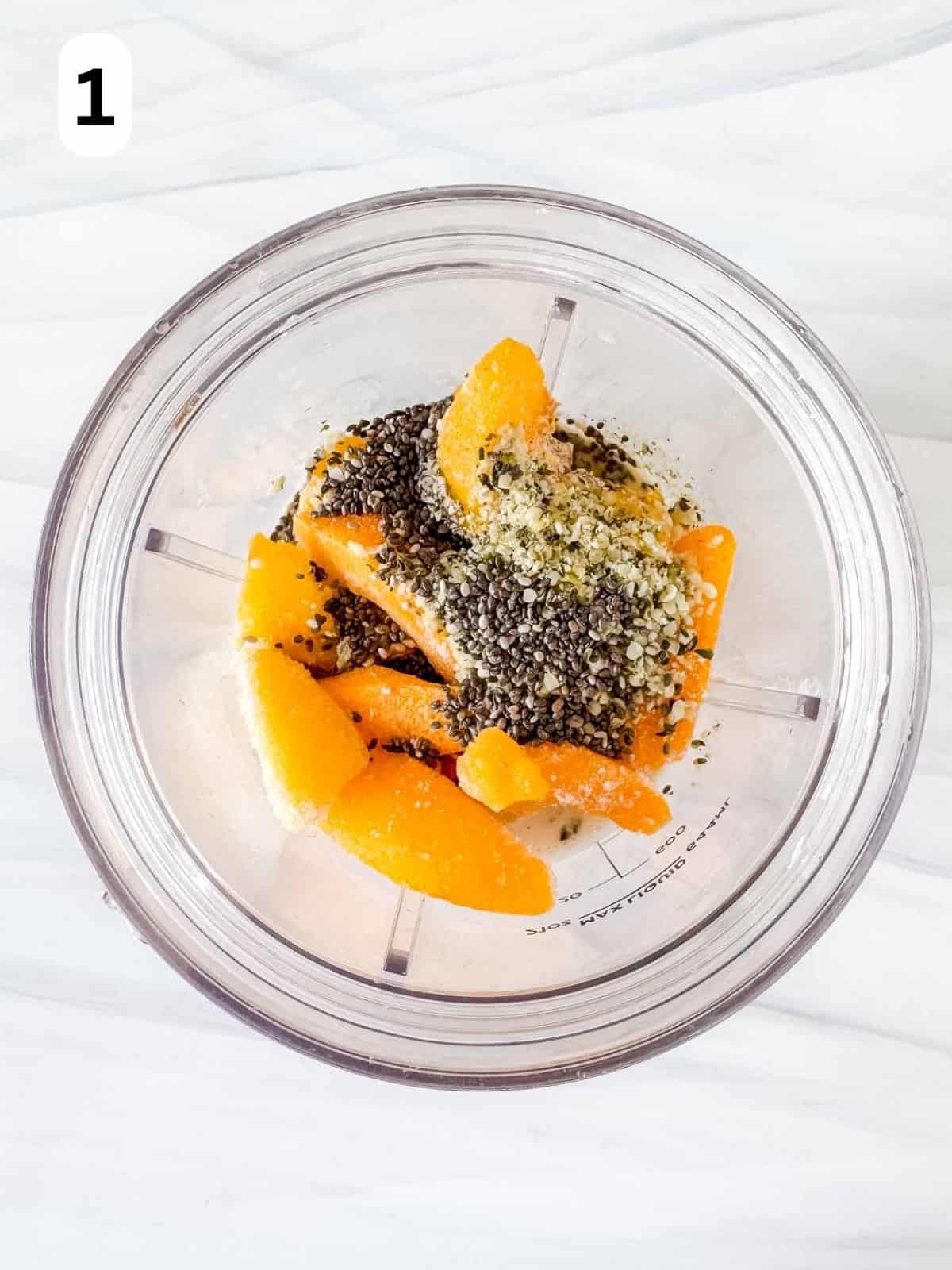 frozen peaches, chia seeds and hemp seeds in a blender cup labelled number one.