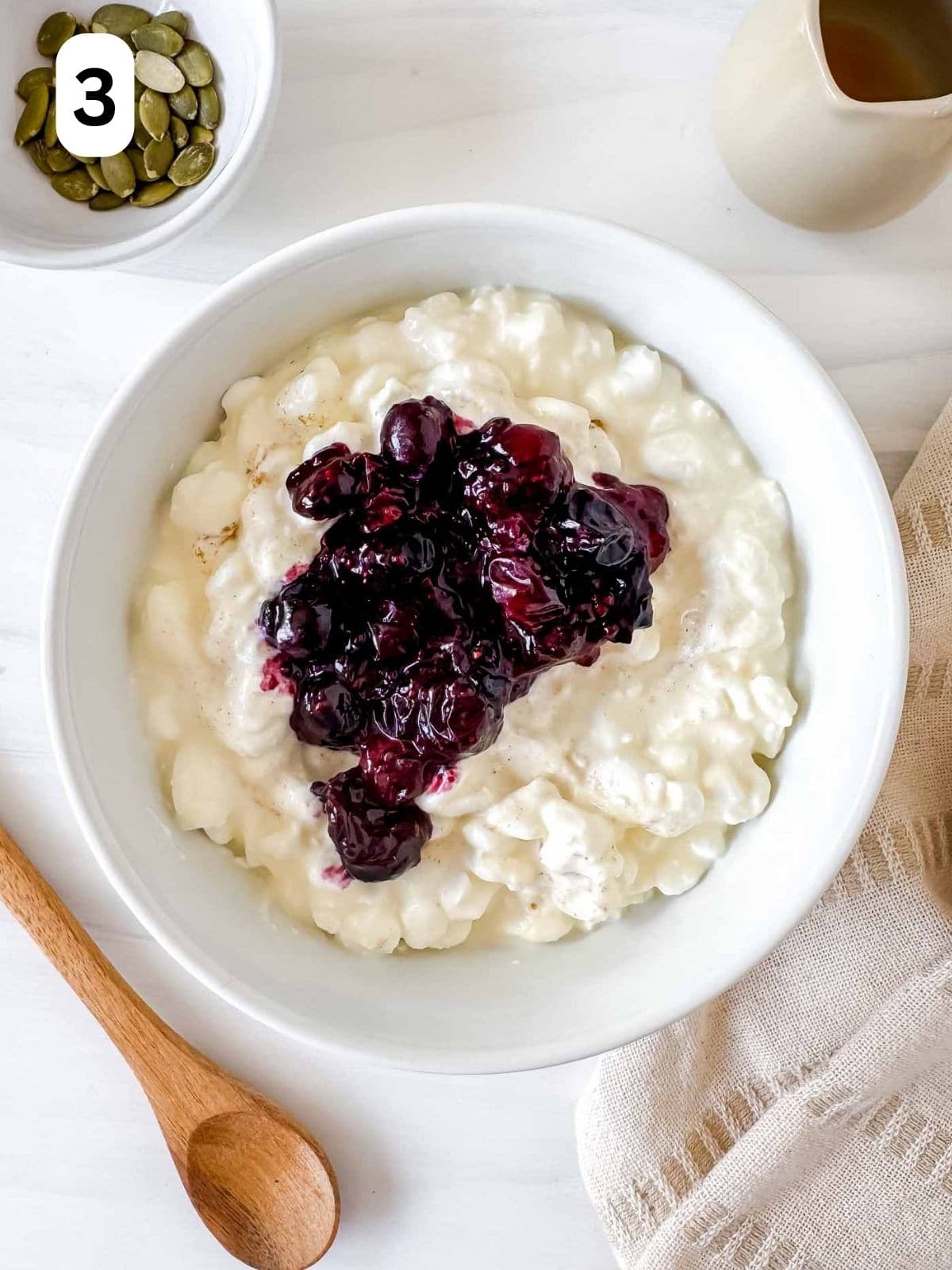 cottage cheese and blueberries in a white bowl labelled number three.
