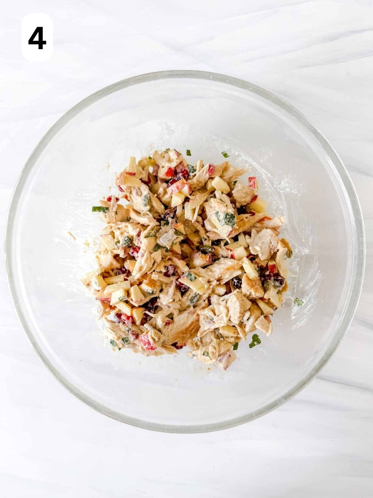 pomegranate chicken salad in a glass bowl labelled number four.