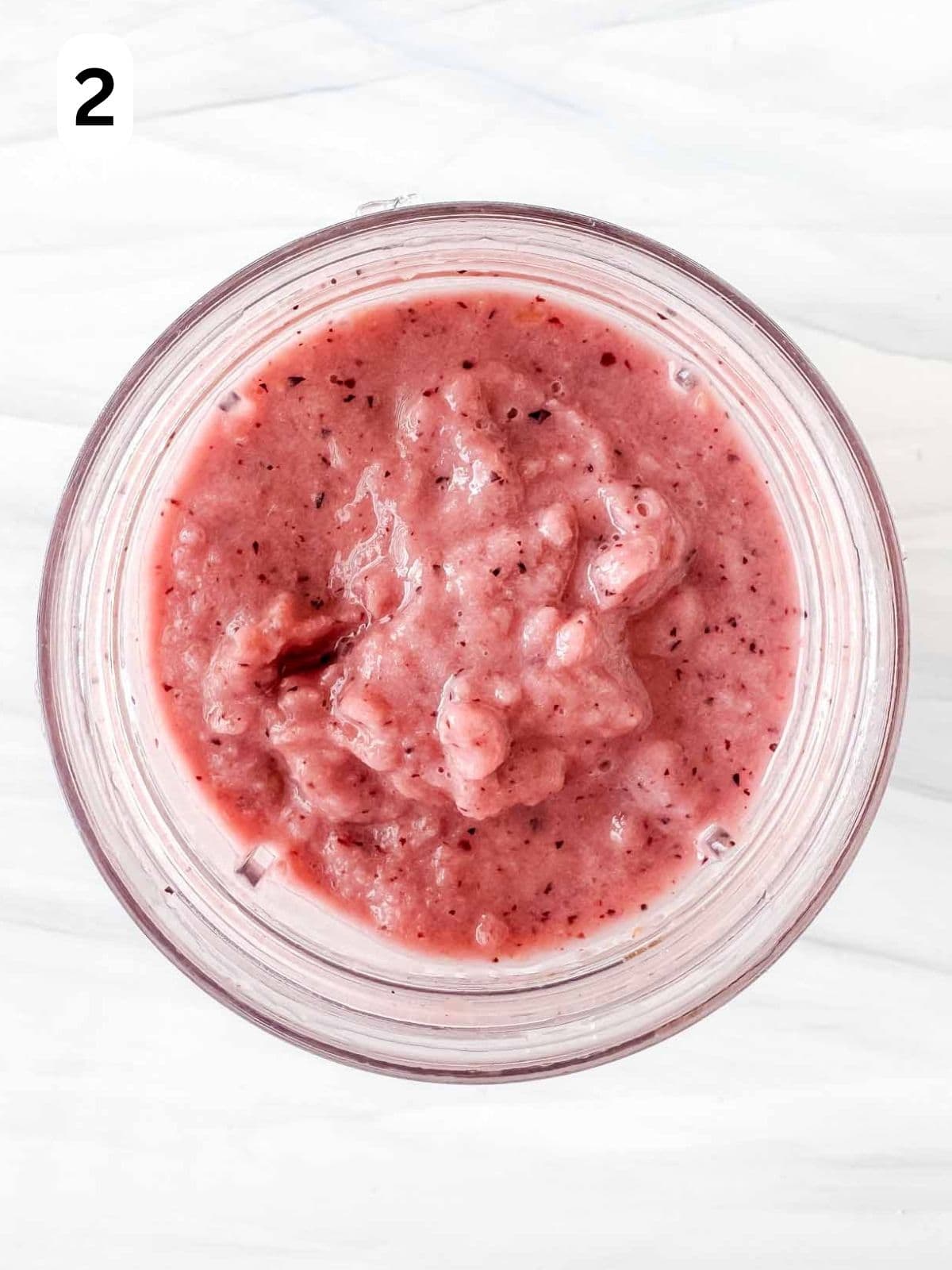 frozen fruit smoothie in a blender cup labelled number two.