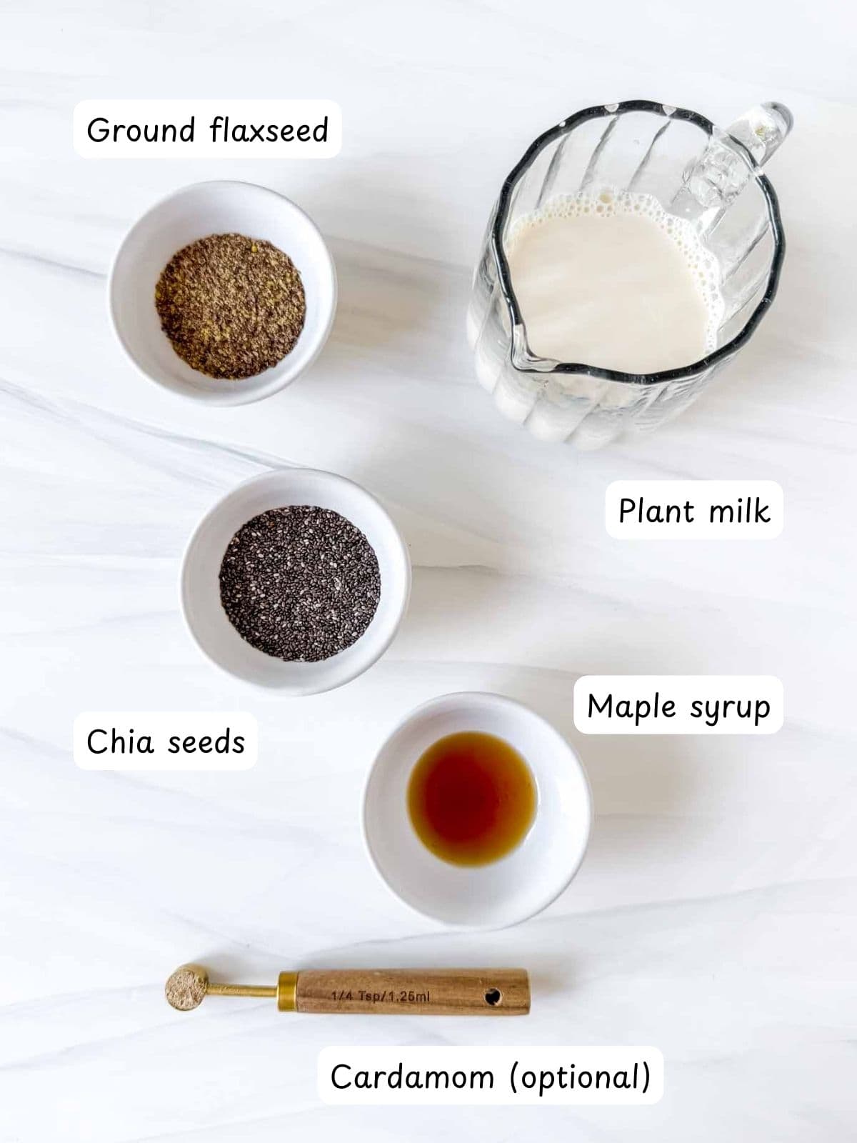 individually labelled ground flaxseed, chia seeds, plant milk, maple syrup and cardamom.
