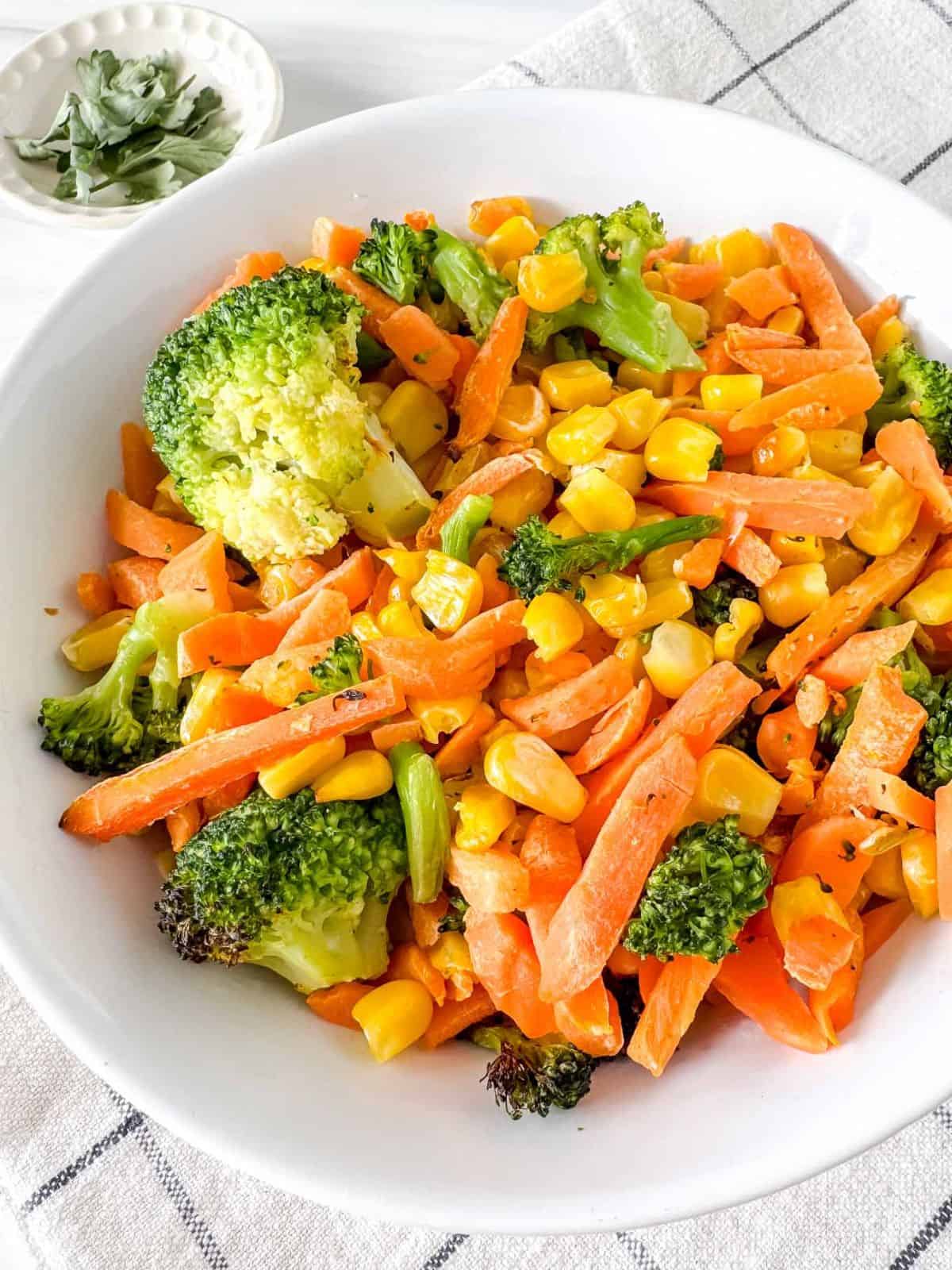 air fryer frozen vegetables in a white bowl.