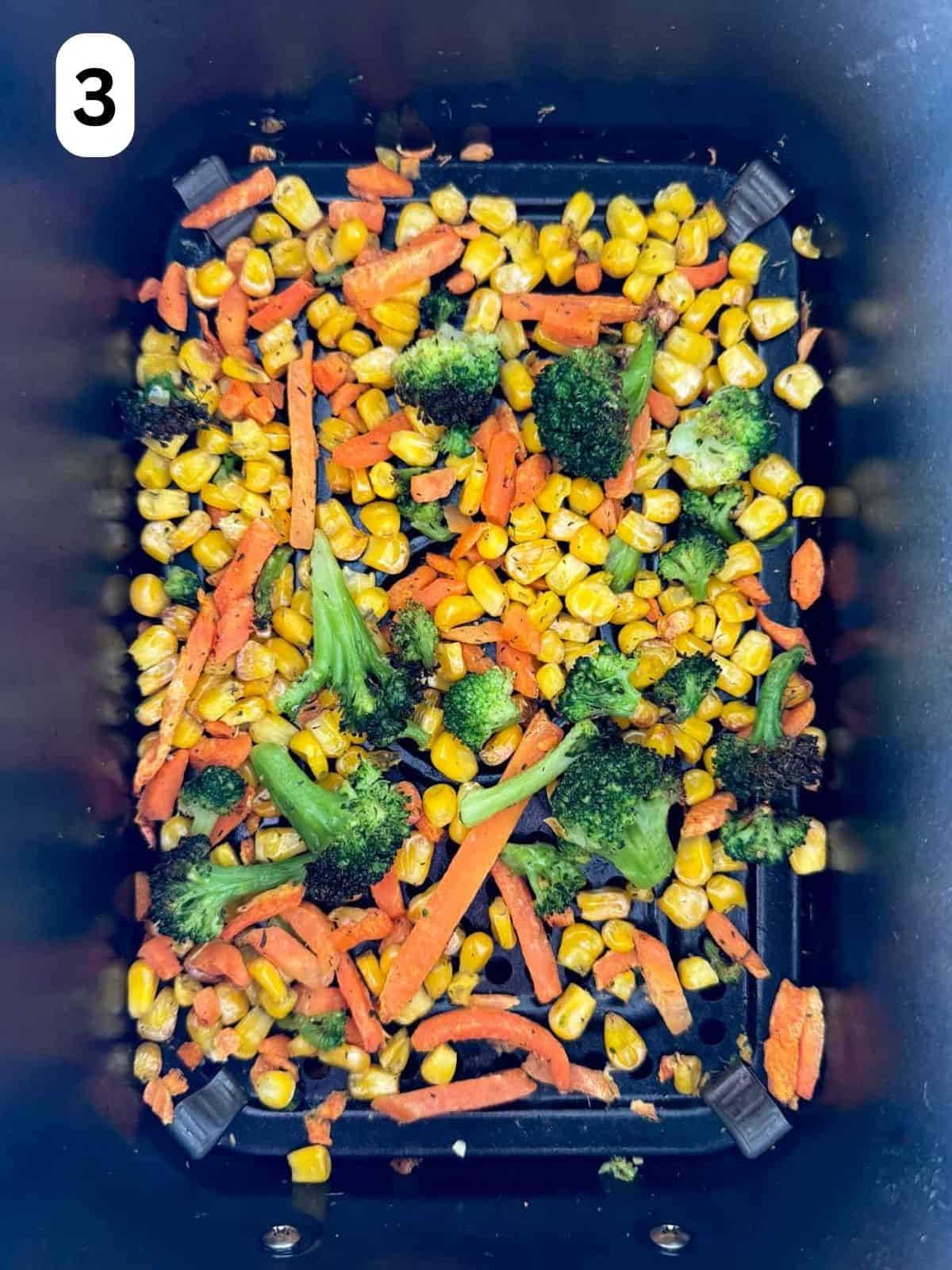 air fried frozen veggies in an air fryer basket labelled number three.
