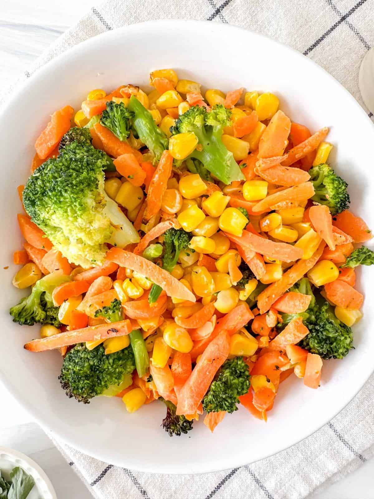 air fryer frozen vegetables in a white bowl.