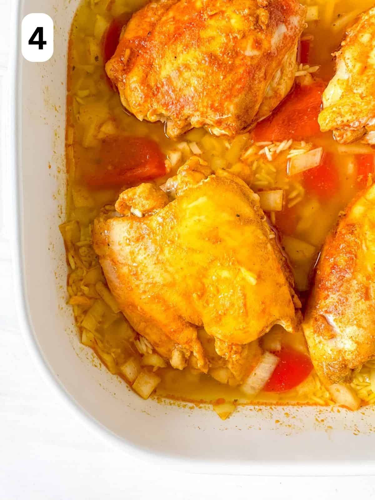 turmeric chicken thighs with rice, bell peppers and onion in a casserole dish labelled number four.