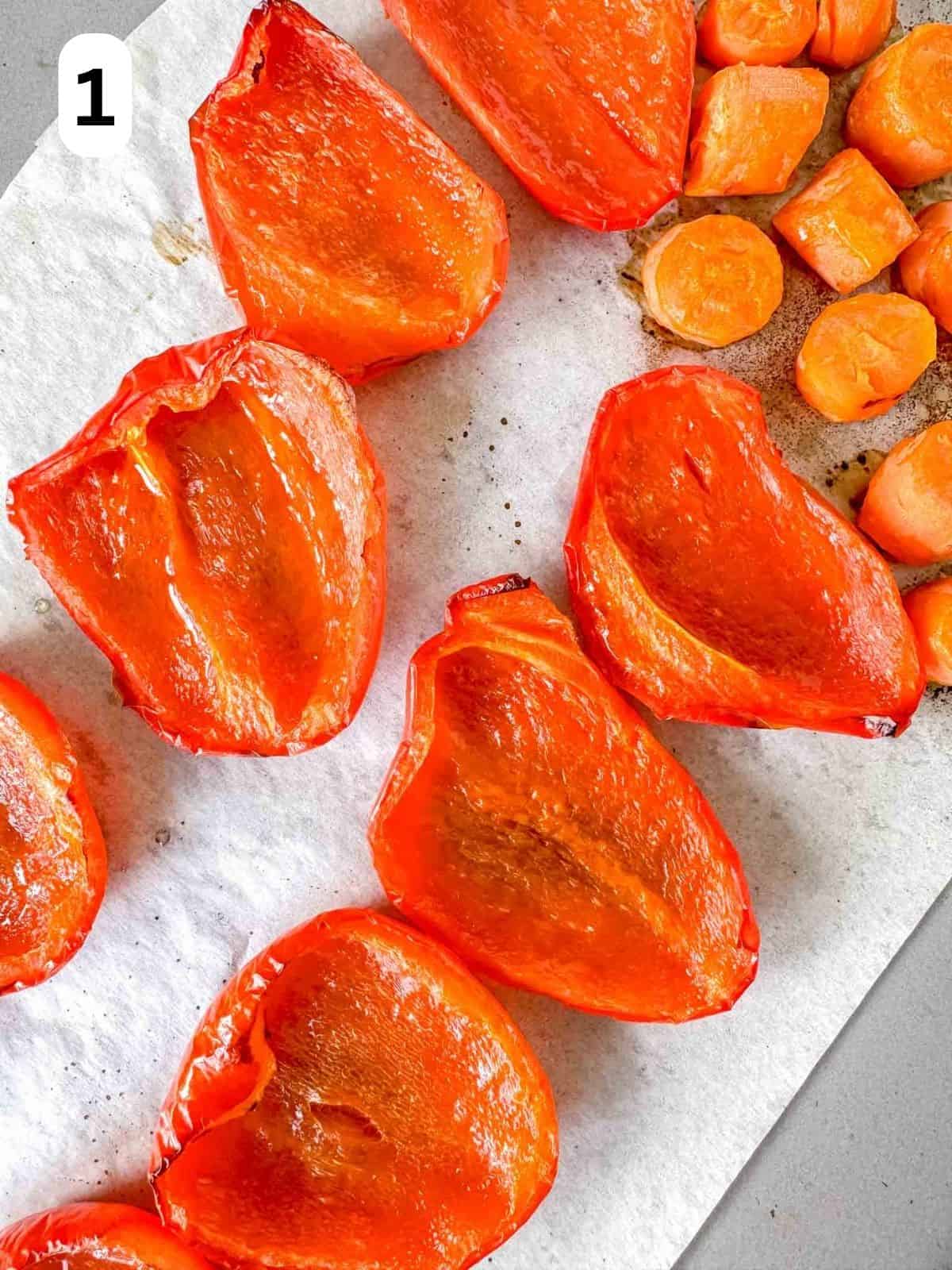 roasted red peppers and carrots on a baking sheet labelled number one.