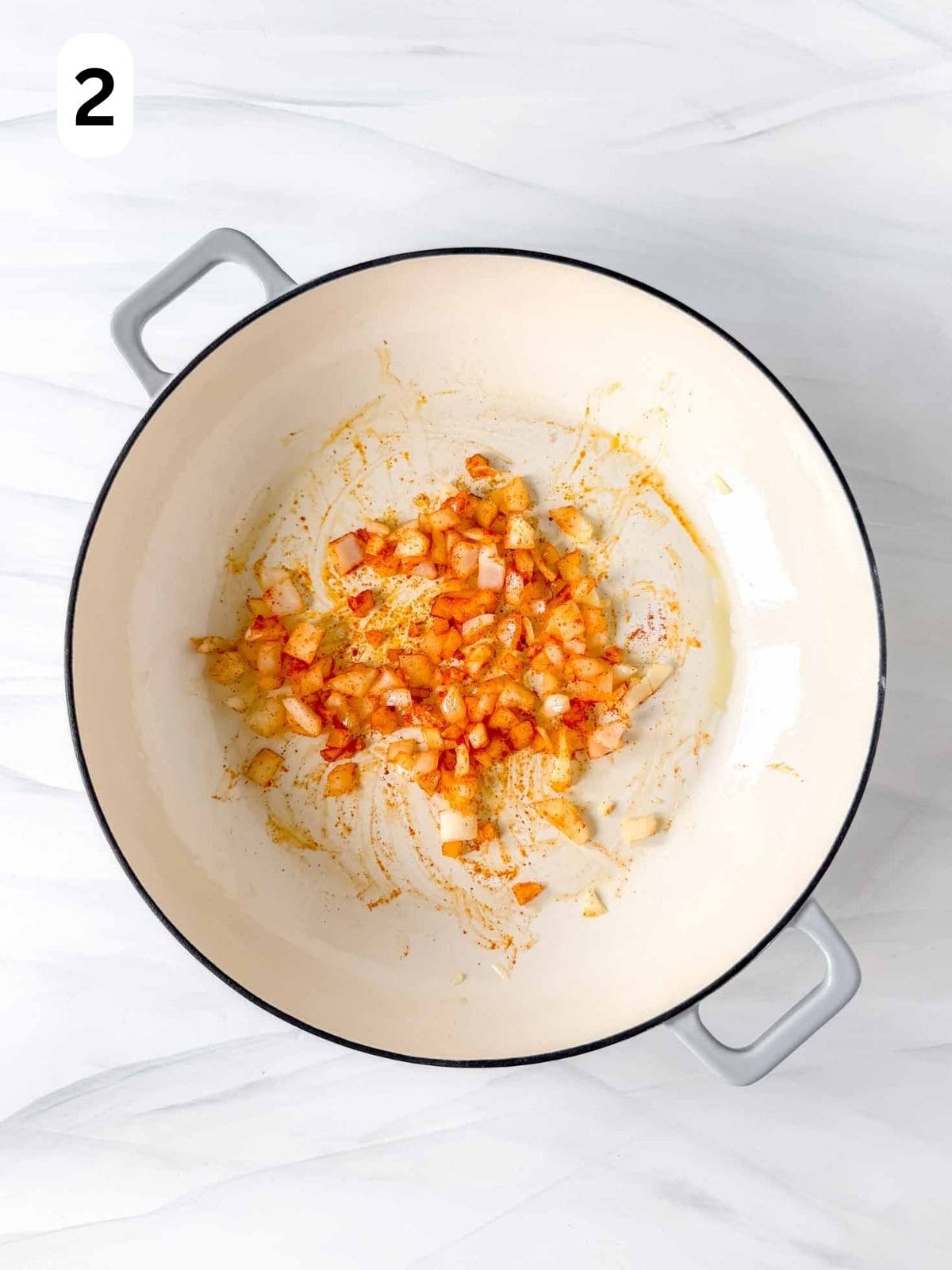 diced onion, garlic and sweet paprika in a skillet labelled number two.