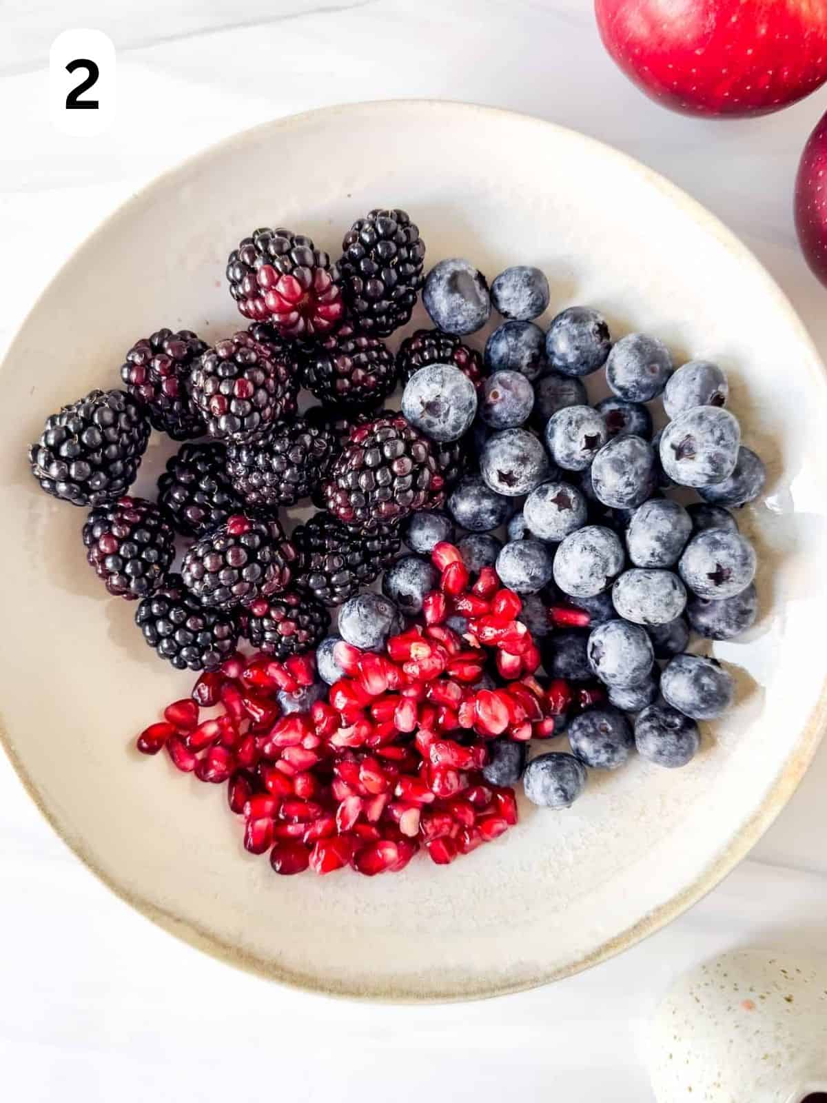 blackberries, pomegranate seeds and blueberries in a bowl labelled number two.