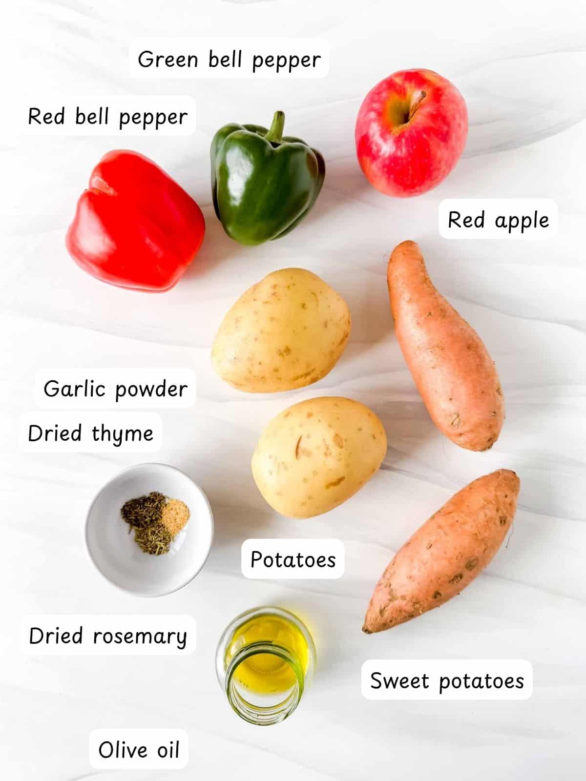 individually labelled potatoes, sweet potatoes, red bell pepper, green bell pepper, red apple, olive oil, garlic powder, dried thyme and dried rosemary.