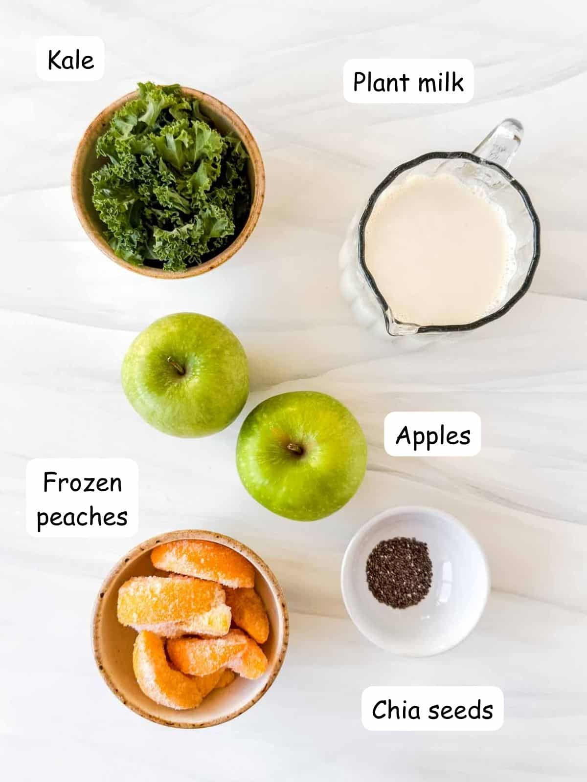 individually labelled apples, kale, frozen peaches, chia seeds and plant milk.