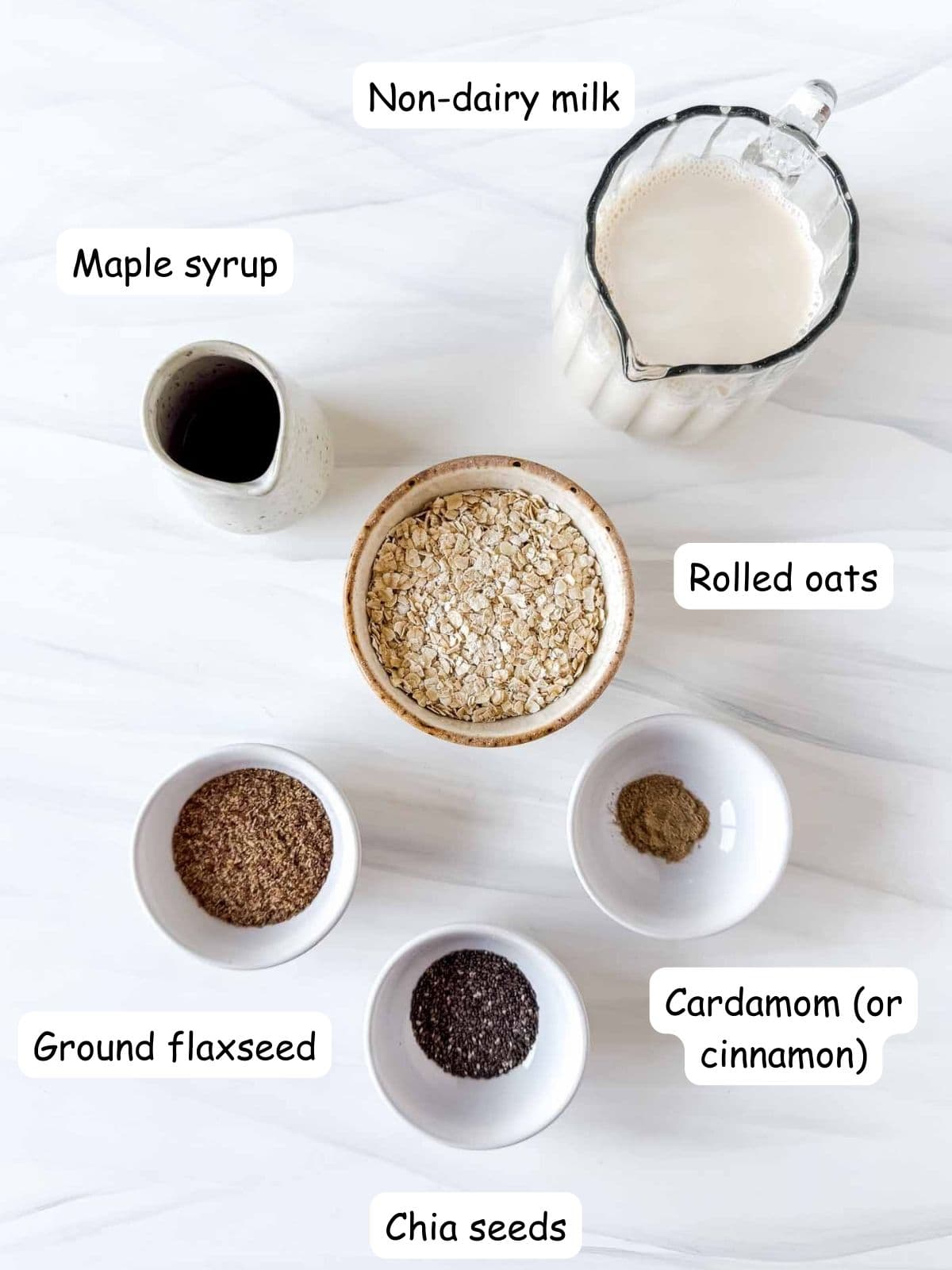 individually labelled ground flaxseed, rolled oats, chia seeds, maple syrup, non dairy milk and cardamom.