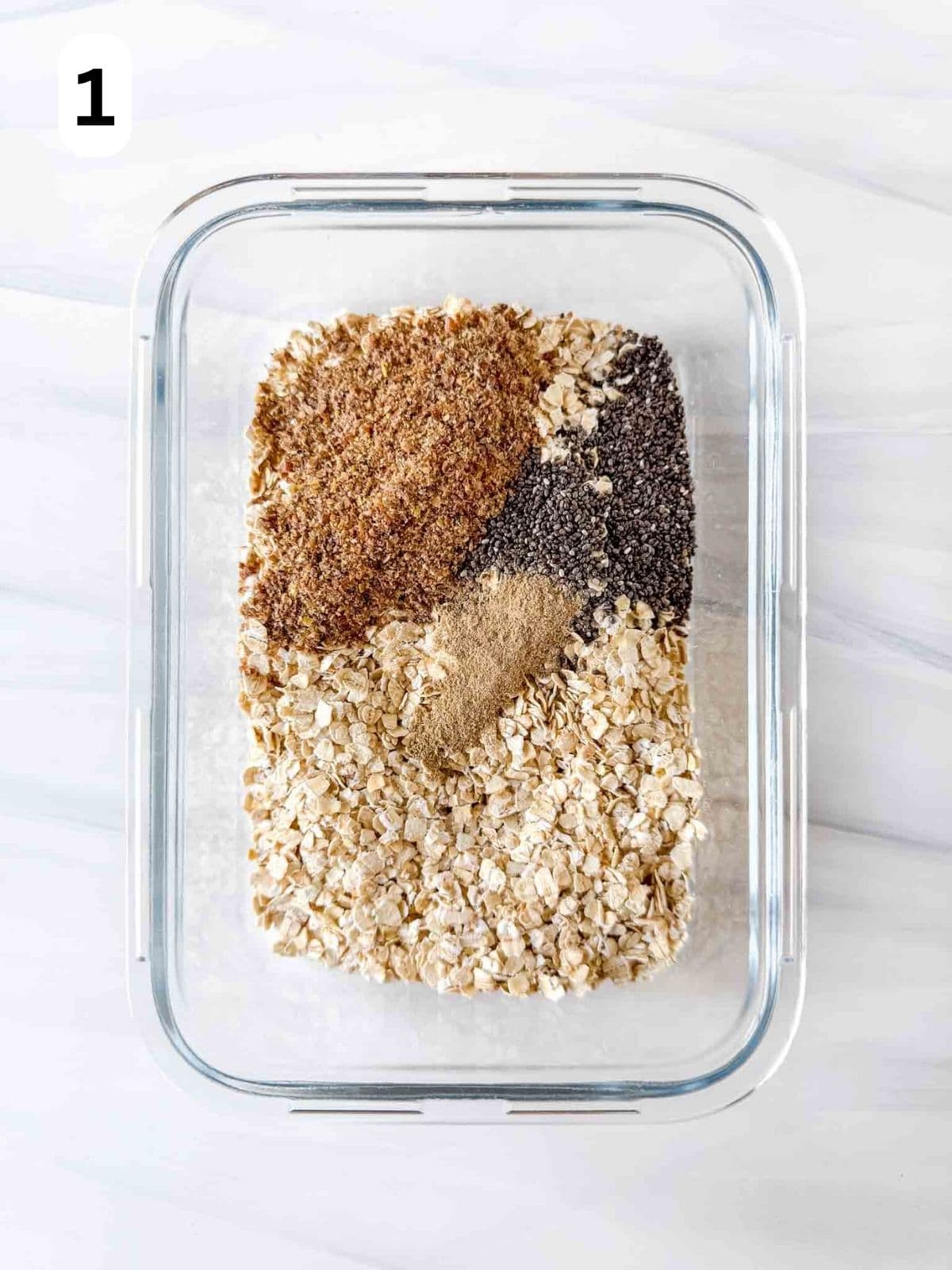 rolled oats, ground flaxseed, chia seeds and cardamom in a glass container labelled number one.