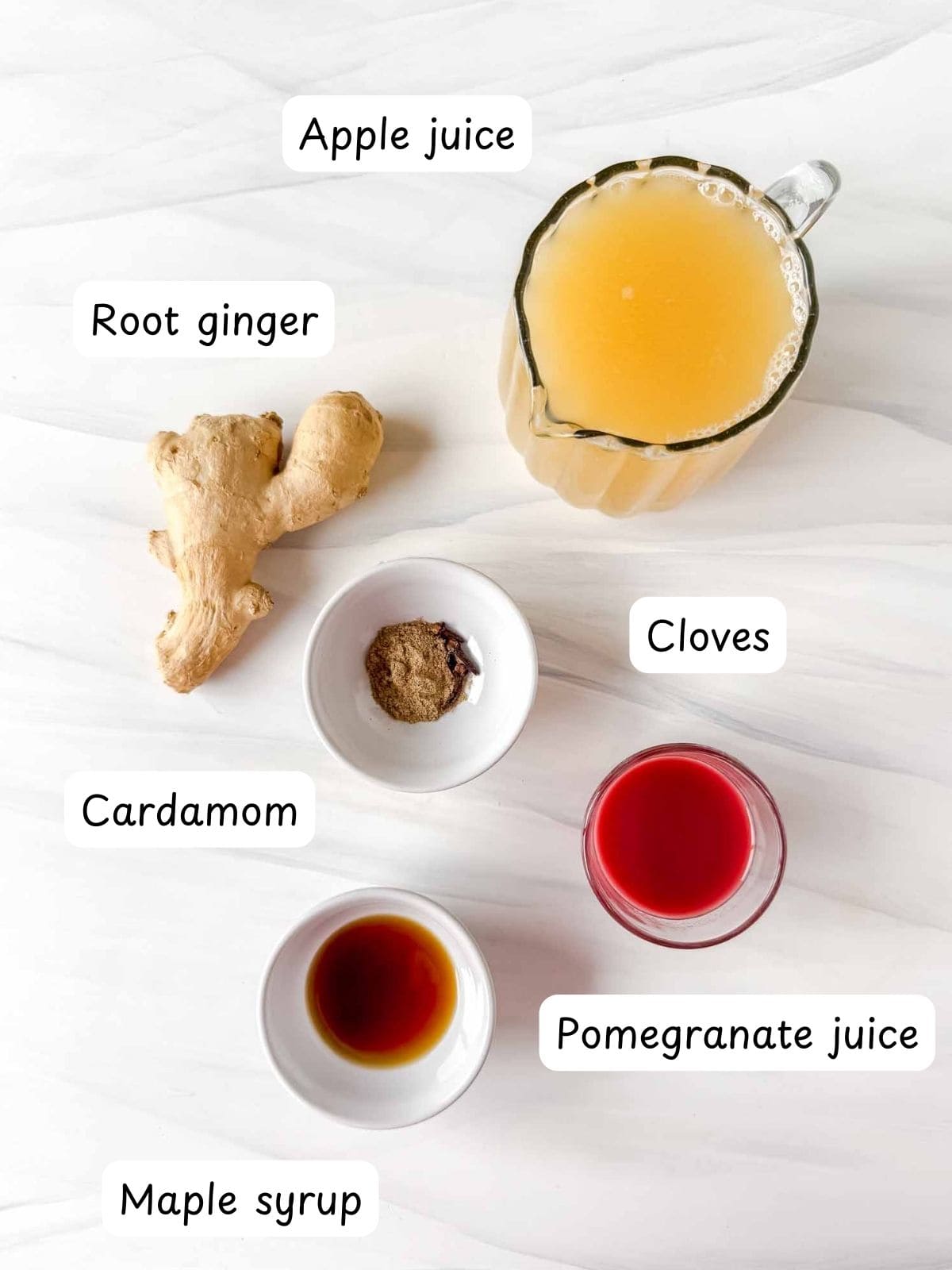 individually labelled apple juice, root ginger, cardamom, cloves, pomegranate juice and maple syrup.