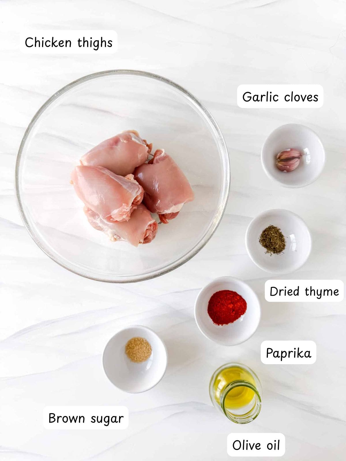 chicken thighs, paprika, olive oil, garlic cloves, brown sugar and dried thyme.