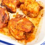 paprika baked chicken thighs in a baking dish.