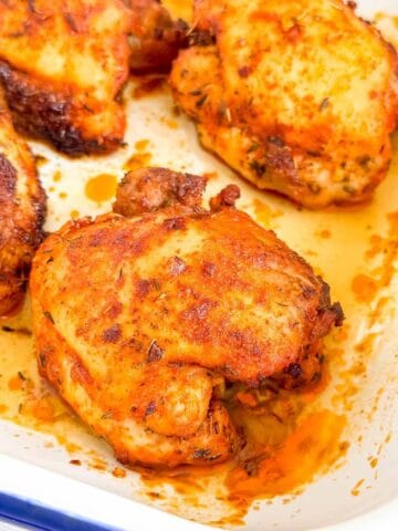 paprika baked chicken thighs in a baking dish.