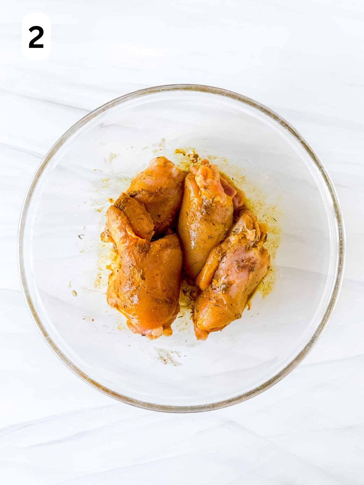 boneless skinless chicken thighs coated in cardamom and spices labelled number two.