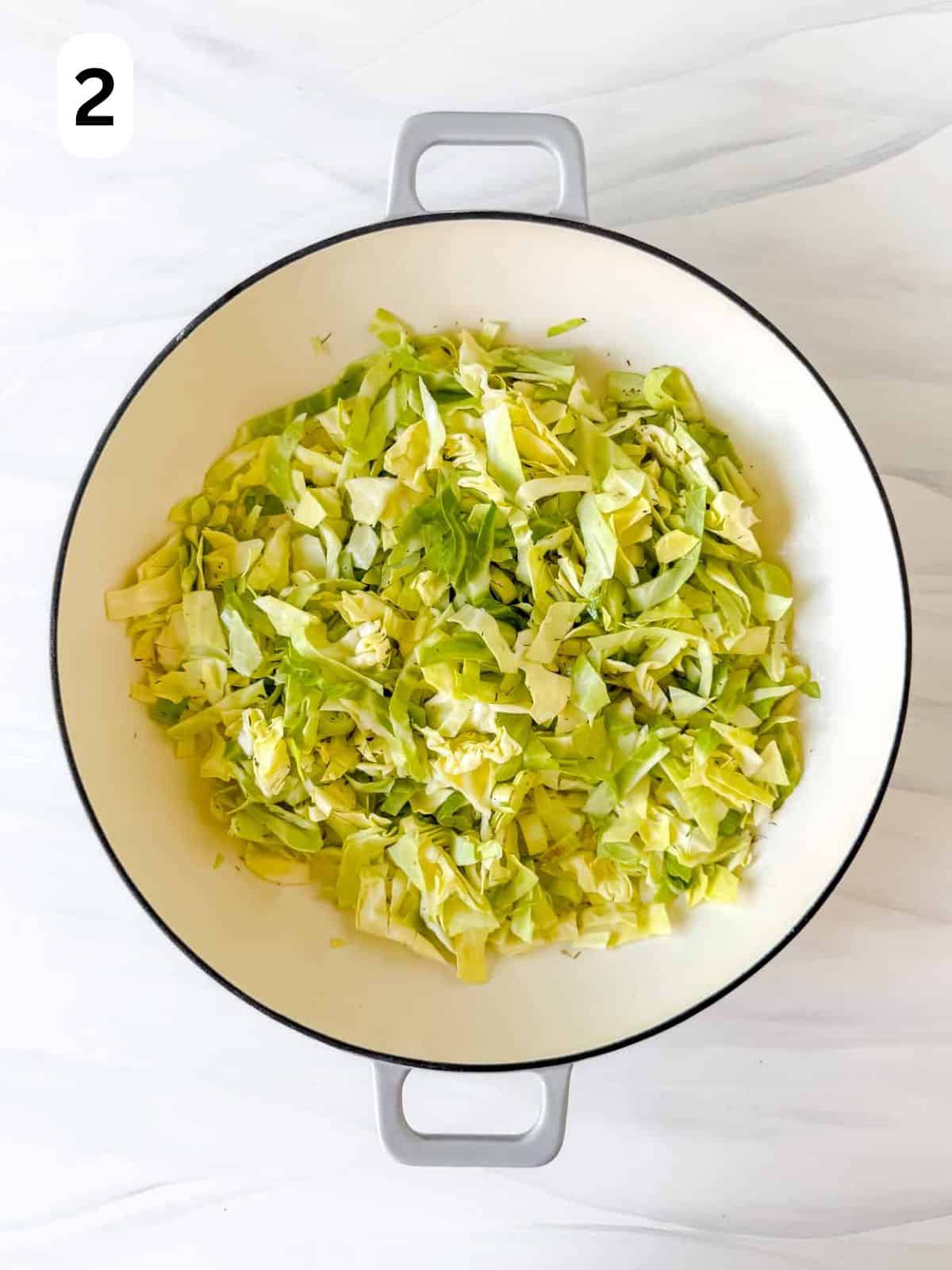 diced leeks and cabbage in a Dutch oven labelled number two.