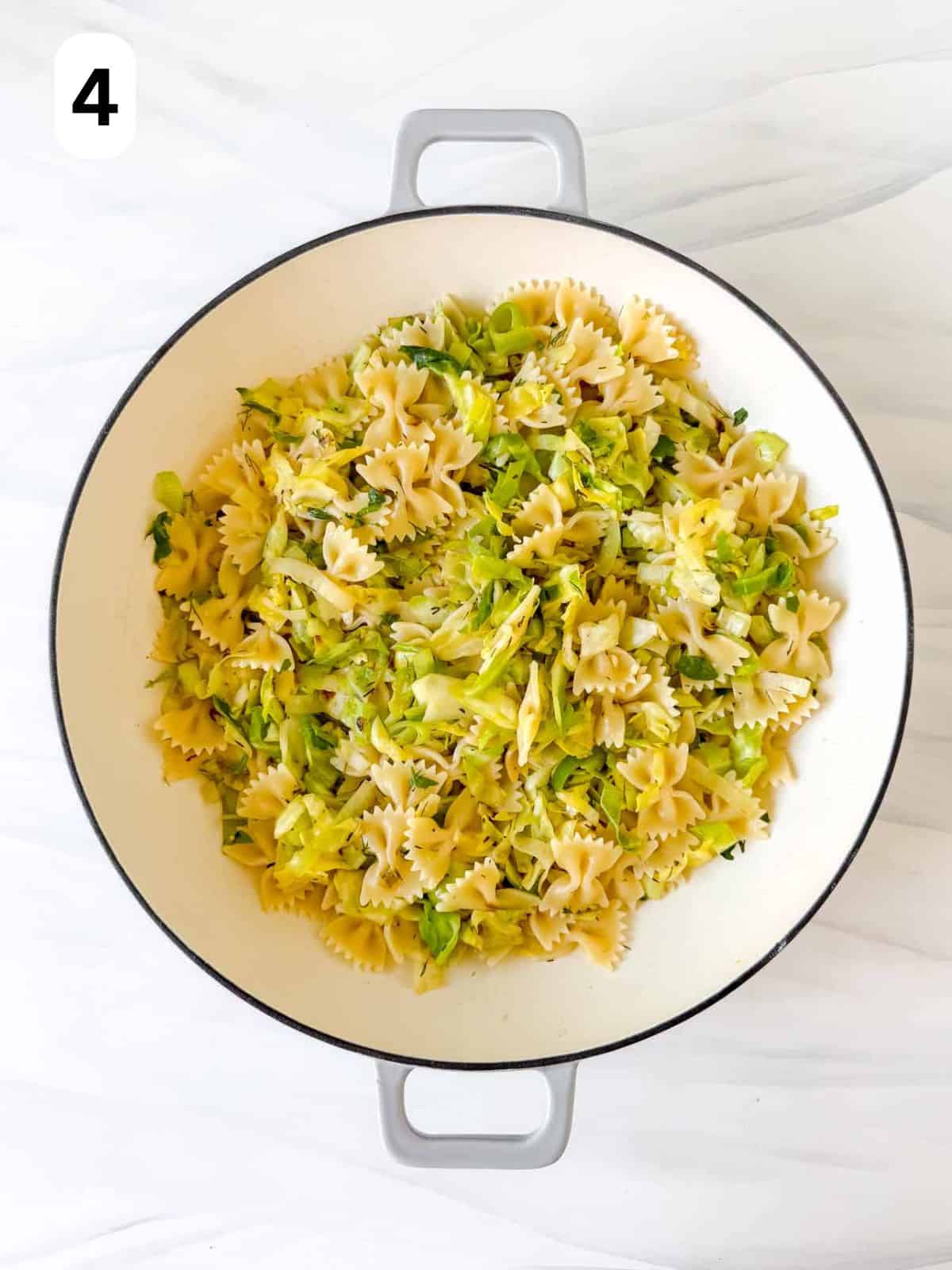 pasta with cabbage and leeks in a Dutch oven labelled number four.