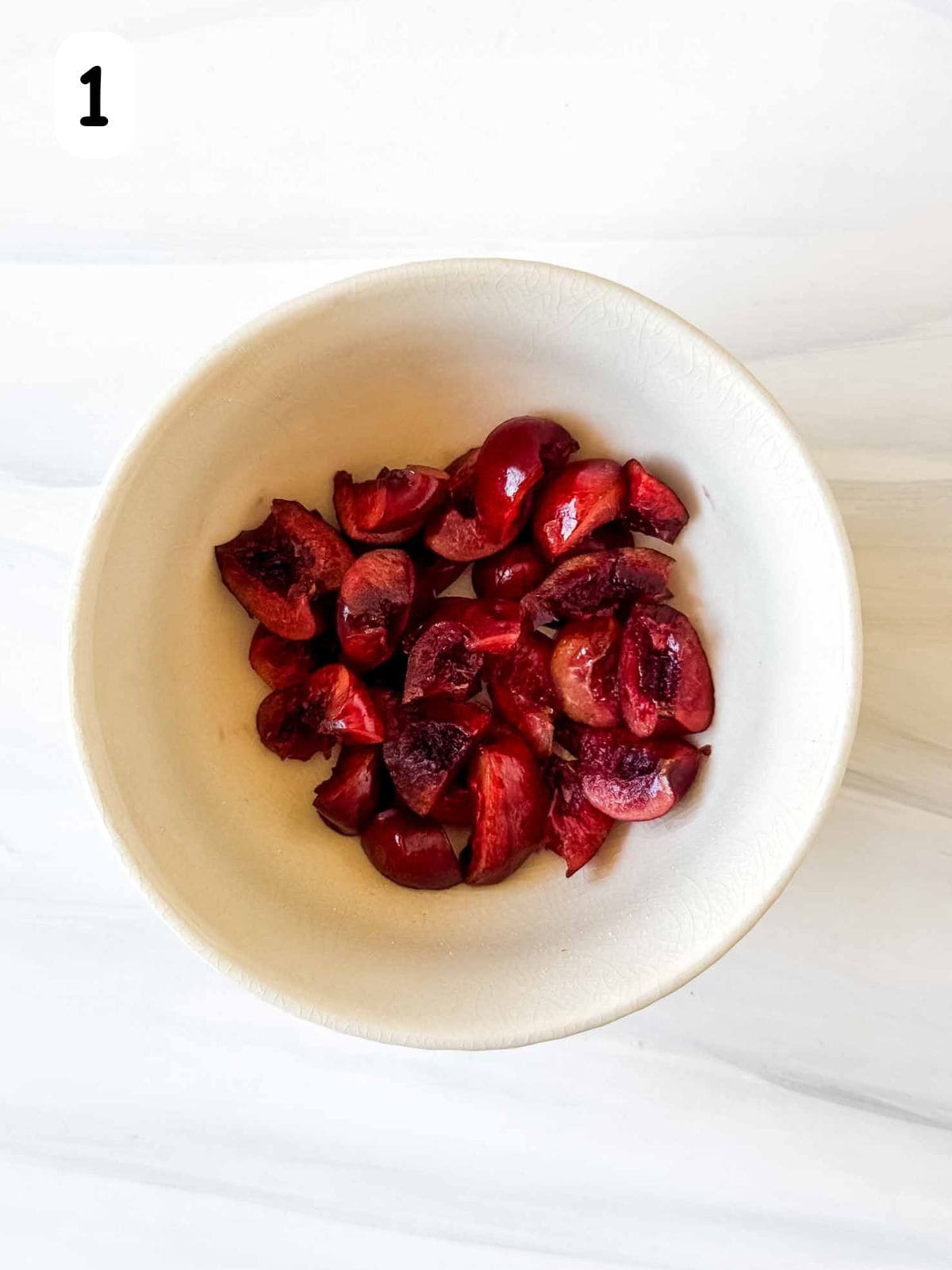 de-stoned cherries cut into small pieces in a bowl labelled number one.