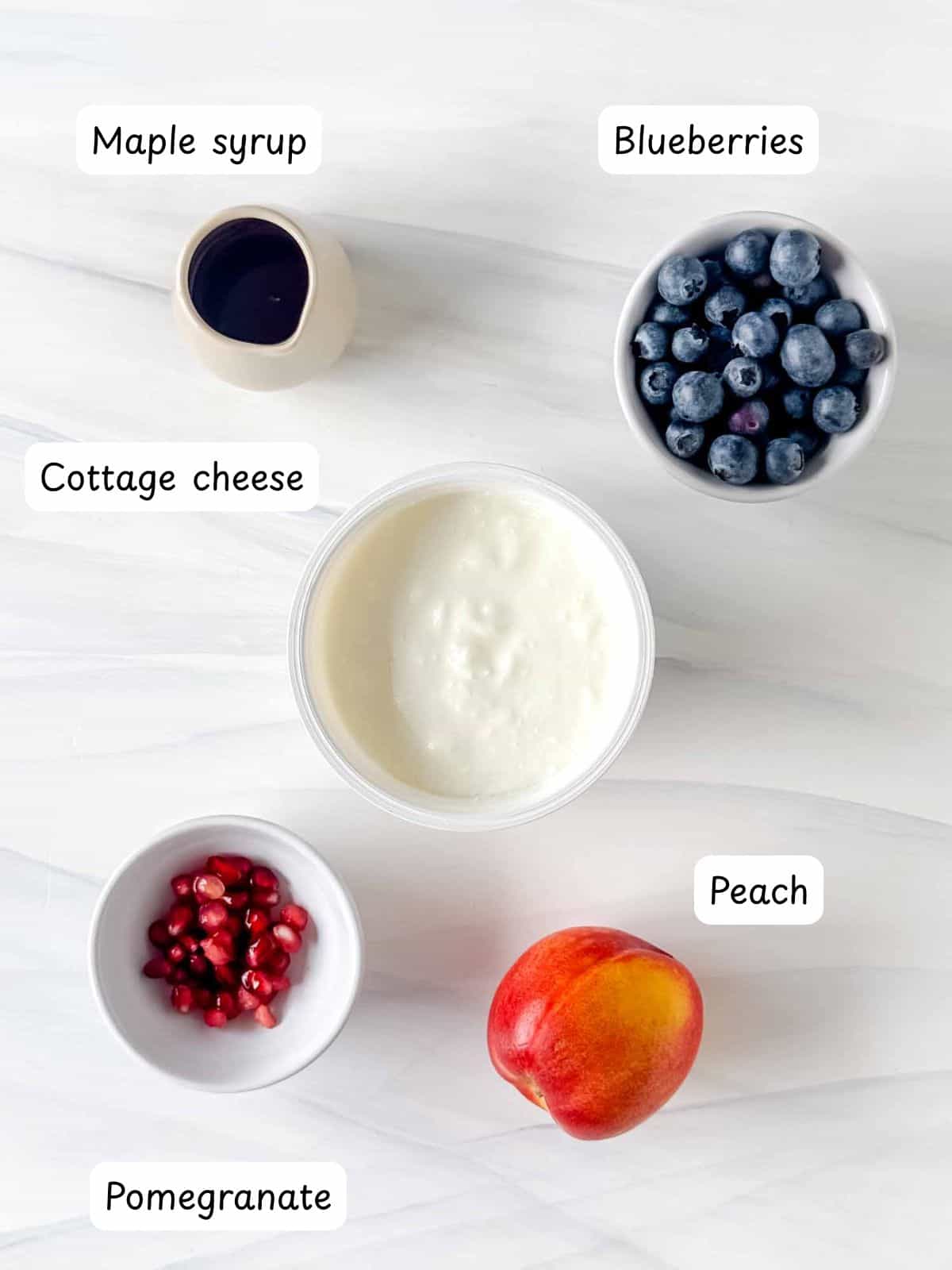 individually labelled cottage cheese, blueberries, pomegranate, peach and maple syrup.