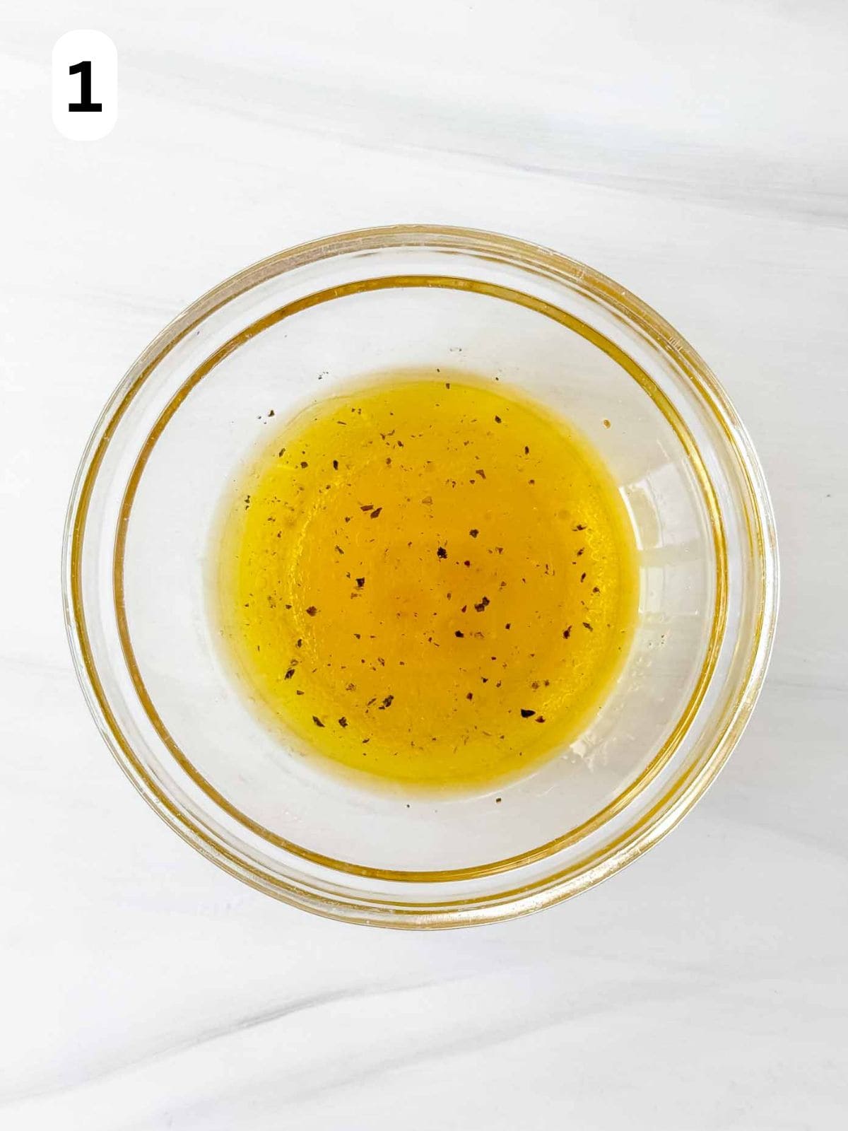 olive oil dressing in a glass bowl labelled number one.