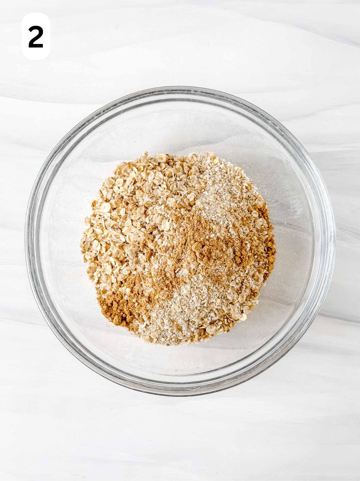 oats, oat flour and ground ginger in a glass bowl labelled number two.