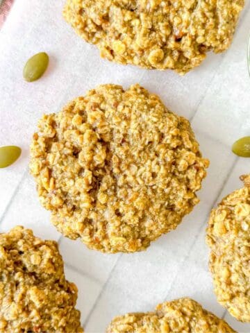 pumpkin seed butter cookies on parchment paper.