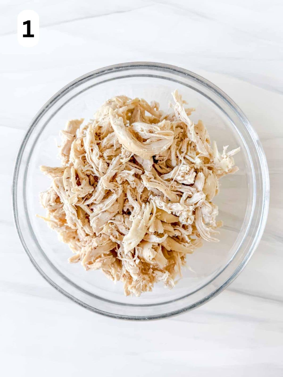 shredded chicken breast in a bowl labelled number one.