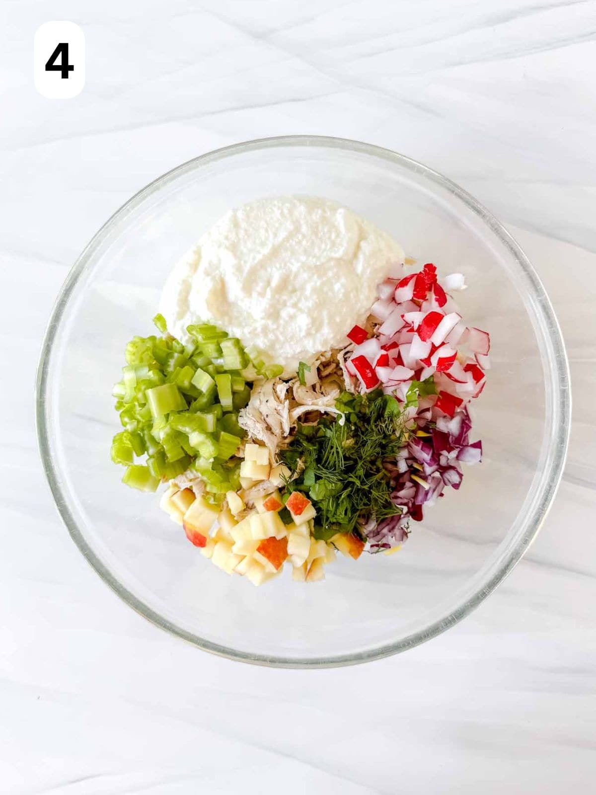 shredded chicken, cottage cheese, celery, apple, radishes, parsley and dill in a glass bowl labelled number four.
