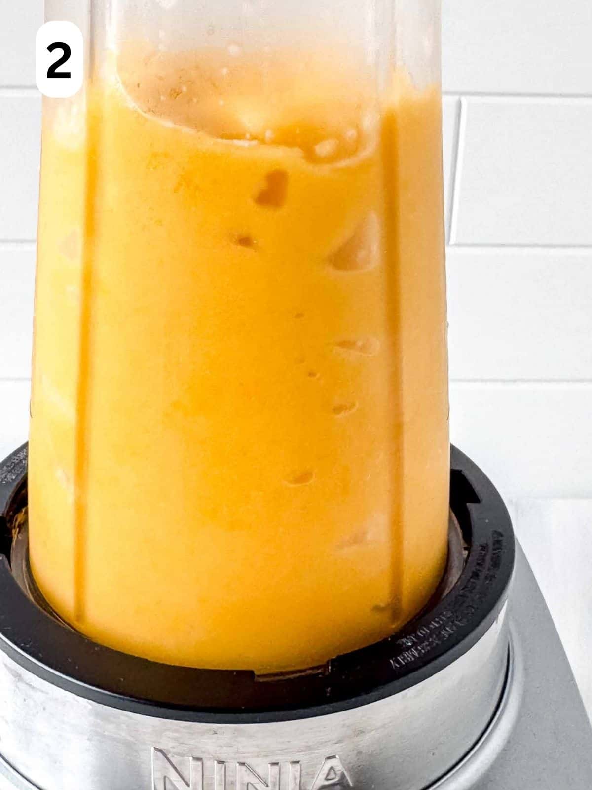 blended frozen peach slushy in a blender labelled number two.