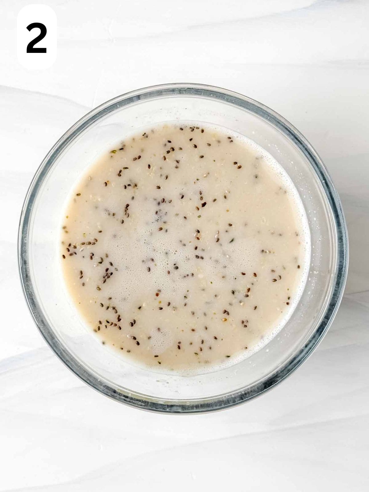 protein overnight oats ingredients in a glass bowl labelled number two.