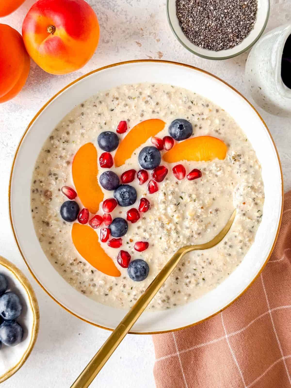 high protein overnight oats without protein powder and no yogurt in a white bowl topped with fruit.