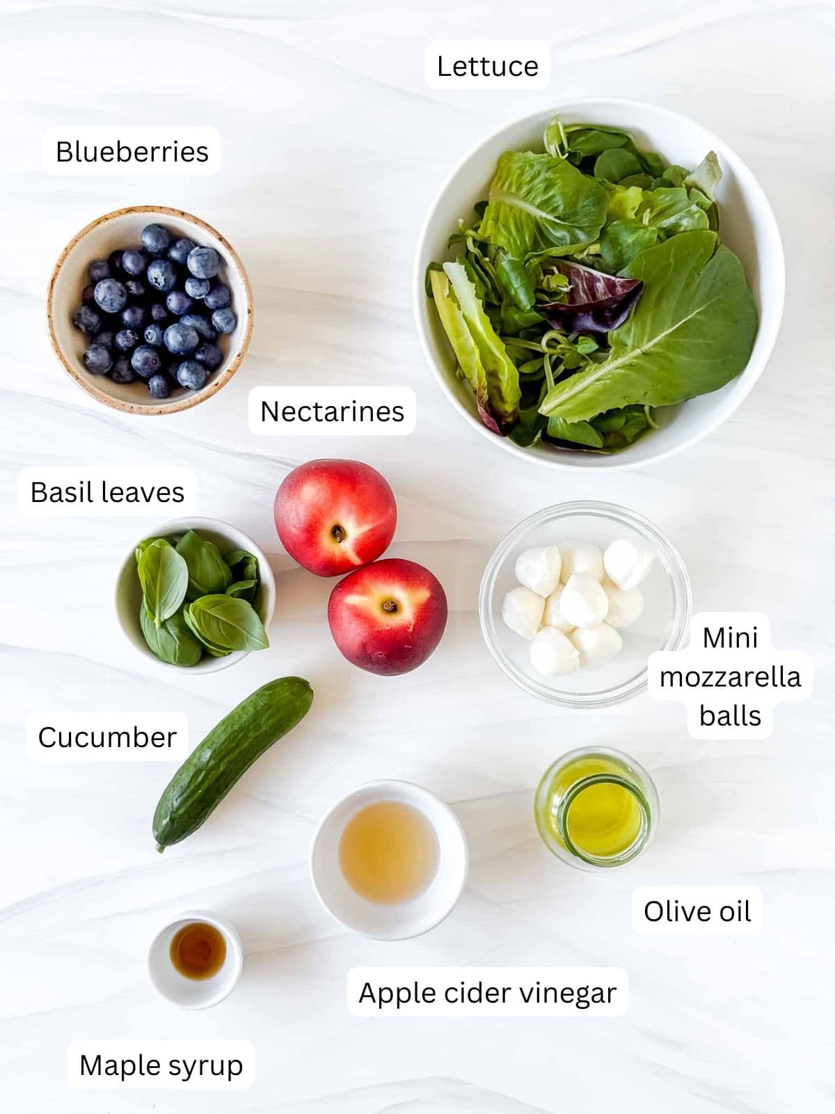 individually labelled nectarines, mini mozzarella balls, blueberries, lettuce, cucumber, olive oil, apple cider vinegar, basil leaves and maple syrup.