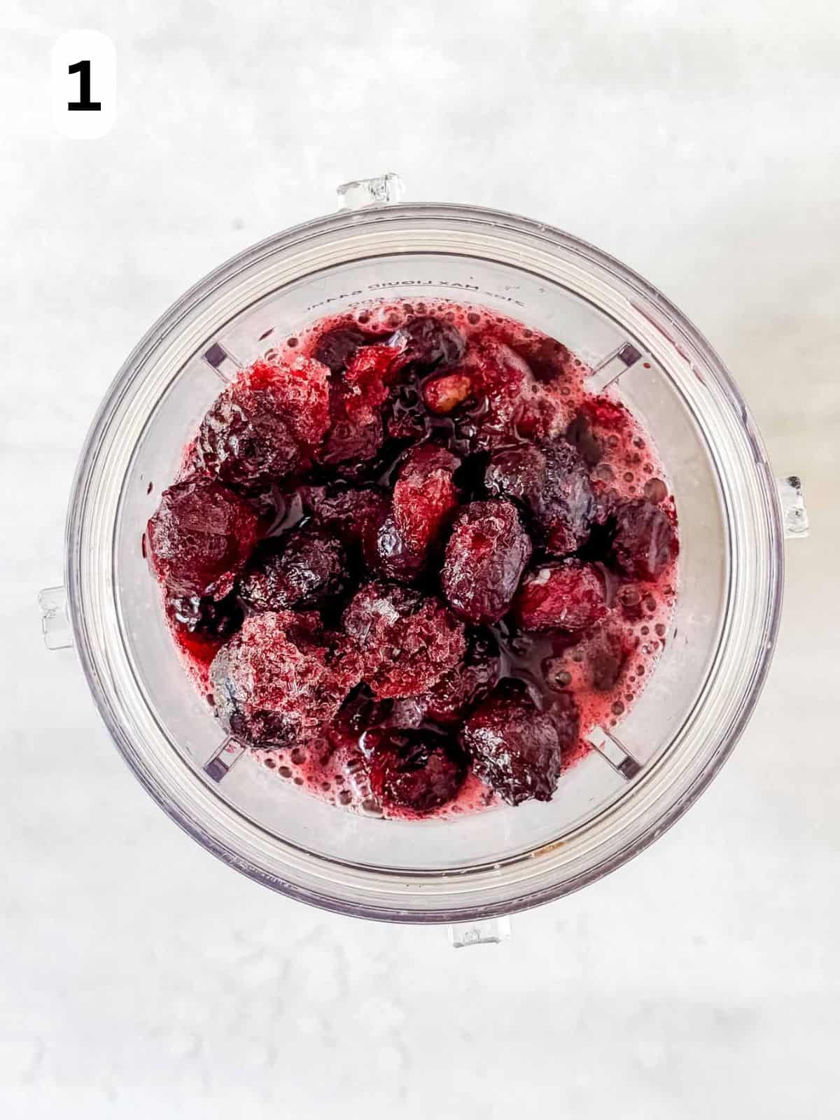 frozen blueberries, apple juice and maple syrup in a blender cup labelled number one.