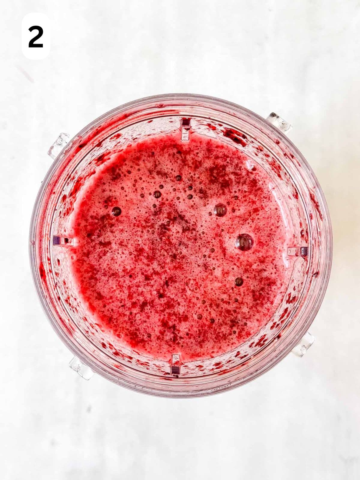 blended blueberry slushie in a blender cup labelled number two.