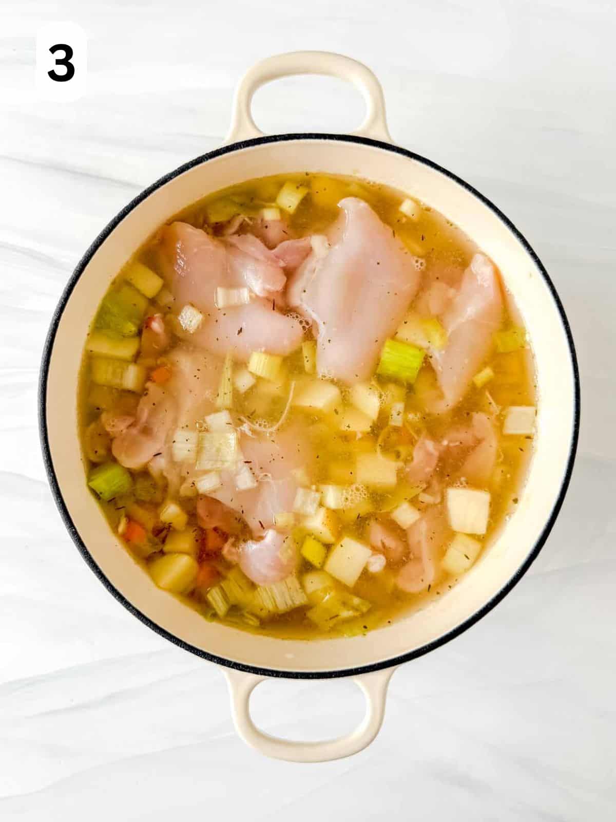chicken thighs in a soup pot with celery, leek, potato, carrot and chicken broth labelled number three.