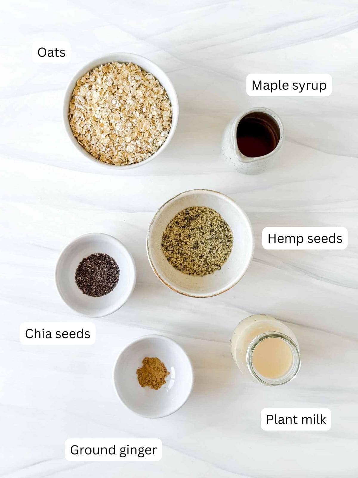 individually labelled oats, maple syrup, hemp seeds, chia seeds, ground ginger and plant milk.